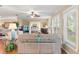 Bright living room with hardwood floors and large windows, offering tranquil views of the home at 2310 Augusta Dr, Spring Hill, FL 34606