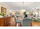 Open-concept living room with hardwood floors, chandelier, and comfortable seating that creates a cozy atmosphere at 2310 Augusta Dr, Spring Hill, FL 34606