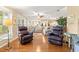 Bright living room featuring hardwood floors, comfortable seating, and large windows to enjoy the outdoor view at 2310 Augusta Dr, Spring Hill, FL 34606