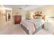 Comfortable main bedroom with a ceiling fan, warm lighting, and ample space for dressers and storage at 2310 Augusta Dr, Spring Hill, FL 34606
