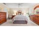 Cozy main bedroom with a ceiling fan, warm lighting, and plenty of space for dressers, creating a relaxing retreat at 2310 Augusta Dr, Spring Hill, FL 34606