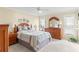 Spacious main bedroom with natural light, including dressers, lamps, and plush bedding to create a relaxing retreat at 2310 Augusta Dr, Spring Hill, FL 34606