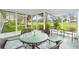 Relaxing screened patio with comfortable seating and views of the lush backyard at 2310 Augusta Dr, Spring Hill, FL 34606