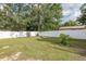 Spacious, fully fenced backyard with a manicured lawn and mature trees provides a private retreat at 27263 Warner Ave, Brooksville, FL 34602