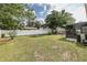 Expansive backyard featuring a lush lawn, mature trees, and a fire pit for outdoor enjoyment at 27263 Warner Ave, Brooksville, FL 34602