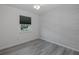 Bright bedroom features a ceiling fan and light gray wood-look flooring at 27263 Warner Ave, Brooksville, FL 34602