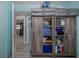 Bedroom featuring gray wood-look floors, open closet, and storage on top at 27263 Warner Ave, Brooksville, FL 34602