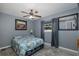 Comfortable bedroom with blue quilt, ceiling fan, and ample natural light at 27263 Warner Ave, Brooksville, FL 34602