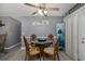 Cozy dining area featuring a round table, decorative ceiling fan, and modern gray walls at 27263 Warner Ave, Brooksville, FL 34602