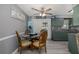 Cozy dining area with seating for four, seamlessly connected to the modern kitchen with gray walls at 27263 Warner Ave, Brooksville, FL 34602
