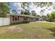 Charming single-story brick home with well-maintained lawn and screened in garage at 27263 Warner Ave, Brooksville, FL 34602