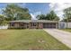 Charming single-story brick home with well-maintained lawn and covered garage at 27263 Warner Ave, Brooksville, FL 34602
