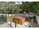 Backyard shot features a covered hot tub with stools and surrounding privacy fence at 27263 Warner Ave, Brooksville, FL 34602