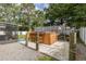 Backyard with a charming hot tub, bar and stools, and a privacy fence adorned with nautical décor at 27263 Warner Ave, Brooksville, FL 34602