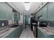 Well-lit kitchen with modern appliances, gray counters, and stylish backsplash at 27263 Warner Ave, Brooksville, FL 34602