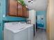 Bright laundry room featuring newer model washer/dryer and ample storage at 27263 Warner Ave, Brooksville, FL 34602