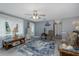 Well-lit living room featuring stylish decor, ceiling fan, and light gray colored walls at 27263 Warner Ave, Brooksville, FL 34602