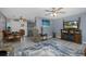 Open-concept living room with adjacent dining area, modern flooring and gray colored walls at 27263 Warner Ave, Brooksville, FL 34602