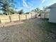 Backyard featuring a tall wooden fence for privacy at 300 Midwood Dr, Plant City, FL 33566
