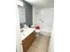 Bathroom with a vanity, toilet, tub, and neutral tile floor at 300 Midwood Dr, Plant City, FL 33566