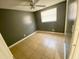 Bedroom features tile floors, a window with blinds, and a ceiling fan at 300 Midwood Dr, Plant City, FL 33566