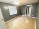 Bedroom features tile floors, a window with blinds, and a ceiling fan at 300 Midwood Dr, Plant City, FL 33566