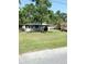 Single story home with a well-maintained front yard and mature shade trees at 300 Midwood Dr, Plant City, FL 33566