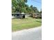 Charming single-story home with a well-maintained front yard and mature trees at 300 Midwood Dr, Plant City, FL 33566