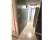 Hallway with tiled floor, neutral paint, and a view of several doorways at 300 Midwood Dr, Plant City, FL 33566