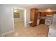 Classic kitchen featuring wood cabinetry, white appliances, and eat-in dining space at 300 Midwood Dr, Plant City, FL 33566