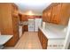 Spacious kitchen with wood cabinets, white appliances, and tile flooring at 300 Midwood Dr, Plant City, FL 33566