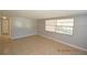 Bright living room with neutral walls, tile flooring, and natural light from windows at 300 Midwood Dr, Plant City, FL 33566