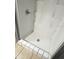 Shower stall with white walls, built-in shelving, and tile flooring at 300 Midwood Dr, Plant City, FL 33566