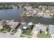 Waterfront home featuring lush landscaping, private boat dock, and serene lake views from an elevated perspective at 3140 Jackson Dr, Holiday, FL 34691