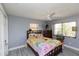 Bedroom with a ceiling fan and bright sunflower themed bedding set at 3140 Jackson Dr, Holiday, FL 34691