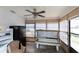 Sunroom with a tanning bed, storage, and a ceiling fan at 3140 Jackson Dr, Holiday, FL 34691