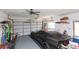 Well-organized garage with a sleek black sports car parked inside at 3140 Jackson Dr, Holiday, FL 34691
