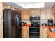 Modern kitchen with stainless steel appliances, stylish wood cabinets, and ample counter space at 3140 Jackson Dr, Holiday, FL 34691