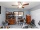 Office area with a desk, cabinet, ceiling fan, and a window for natural light at 3140 Jackson Dr, Holiday, FL 34691