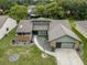 Aerial view of a charming single-story home with a landscaped front yard and a two-car garage at 35046 Smoketree Ln, Dade City, FL 33523