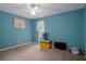 Bedroom with bright paint, ceiling fan, and natural light at 35046 Smoketree Ln, Dade City, FL 33523