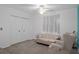 A secondary bedroom has carpet flooring, sofa, chair, ceiling fan, and closet at 35046 Smoketree Ln, Dade City, FL 33523