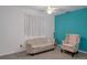 The bedroom has blue accent wall with a ceiling fan, carpet flooring, sofa, and chair at 35046 Smoketree Ln, Dade City, FL 33523