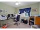 Bright bedroom featuring a ceiling fan and a large window for natural light at 35046 Smoketree Ln, Dade City, FL 33523