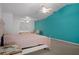 This is a main bedroom with vaulted ceilings, a ceiling fan, dresser, and blue accent wall at 35046 Smoketree Ln, Dade City, FL 33523