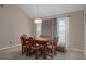Charming dining area featuring a wood table and chairs, complemented by bright lighting and soft drapery at 35046 Smoketree Ln, Dade City, FL 33523