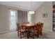 Comfortable dining room with a wooden table, chairs, and curtains at 35046 Smoketree Ln, Dade City, FL 33523