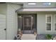 Inviting front entrance with a screened-in porch and decorative plants at 35046 Smoketree Ln, Dade City, FL 33523