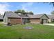 Charming single-story home featuring a landscaped front yard, brick accents, and a two-car garage at 35046 Smoketree Ln, Dade City, FL 33523