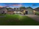 Charming single-story home featuring a landscaped front yard, brick accents, and a two-car garage at 35046 Smoketree Ln, Dade City, FL 33523